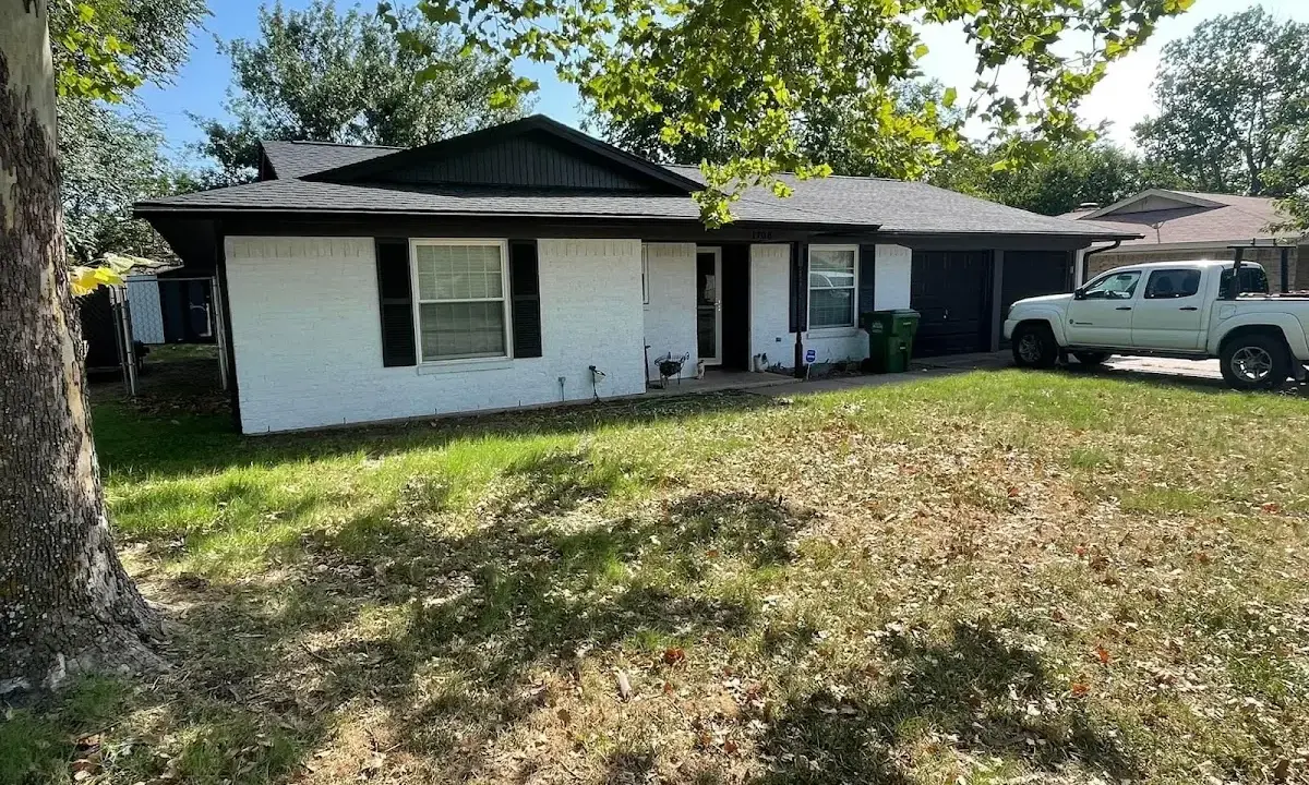Professional roofing crew working on a residential roof in Genoa